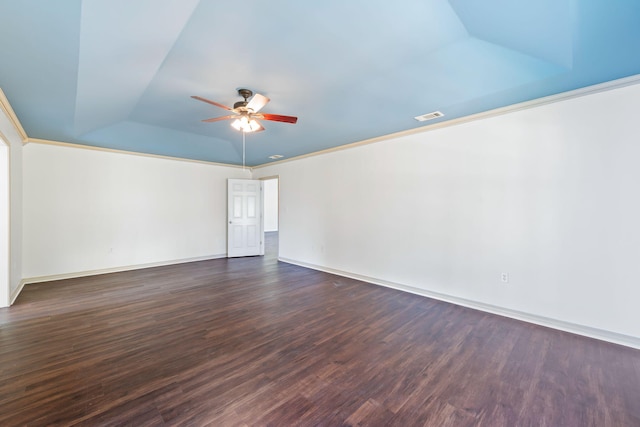 empty room featuring ceiling fan, crown molding, and dark wood-type flooring