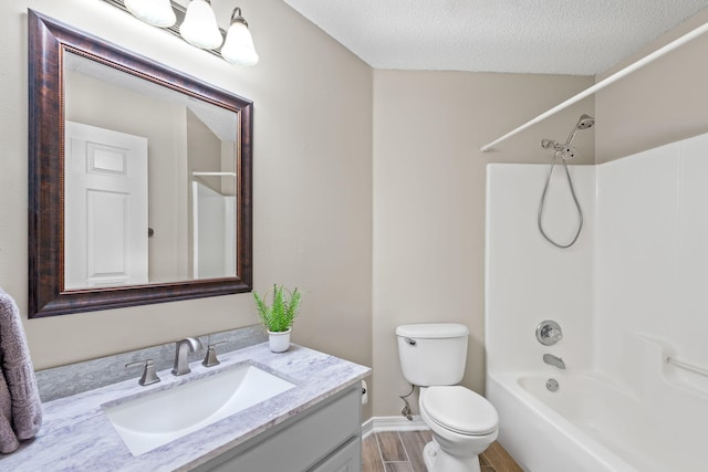 full bathroom with vanity, a textured ceiling, shower / washtub combination, wood-type flooring, and toilet