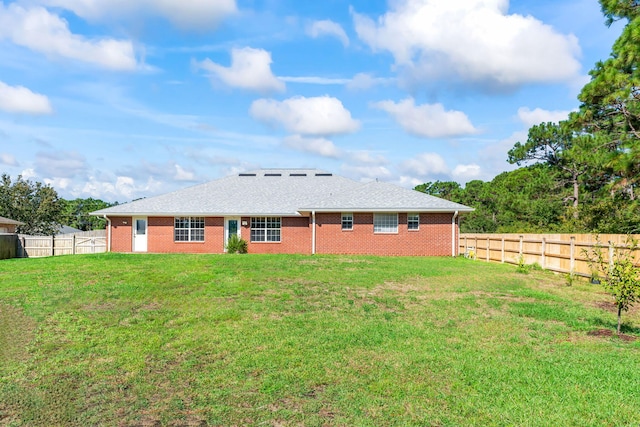 rear view of property with a yard