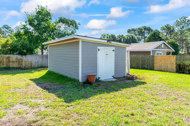 view of outdoor structure featuring a lawn