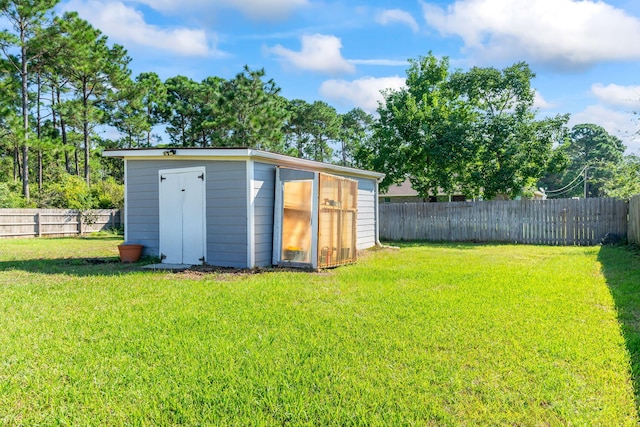 view of outbuilding with a yard