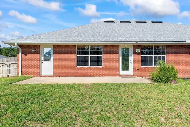 rear view of property with a patio area and a lawn