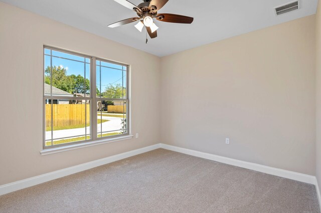 spare room featuring ceiling fan and carpet