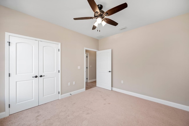 unfurnished bedroom featuring a closet, ceiling fan, and light carpet