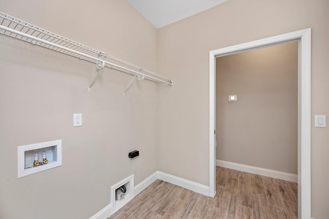 washroom with hookup for a washing machine, hookup for an electric dryer, and light hardwood / wood-style floors