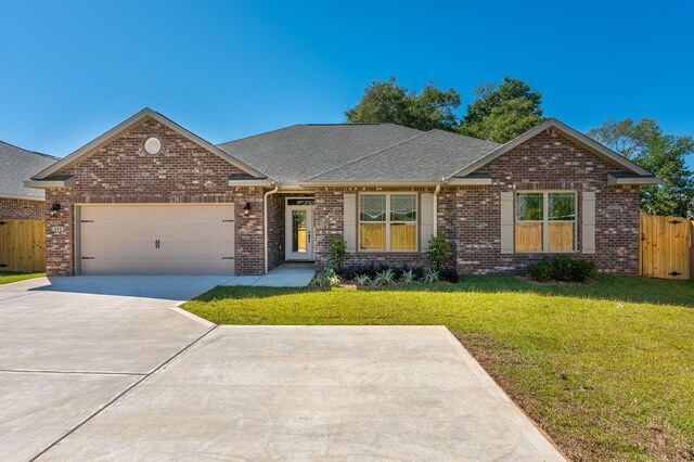 single story home with a garage and a front lawn