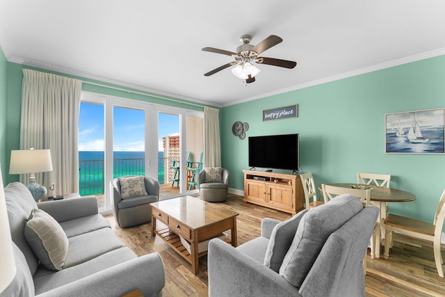 living room with ceiling fan, light hardwood / wood-style floors, and crown molding