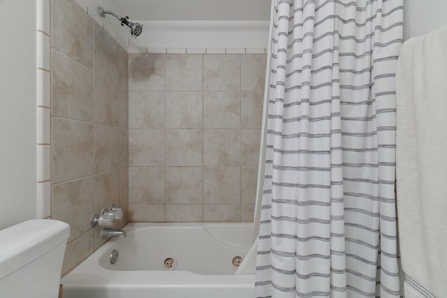 bathroom with shower / bath combination with curtain and toilet