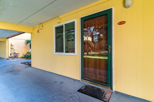 property entrance featuring a patio