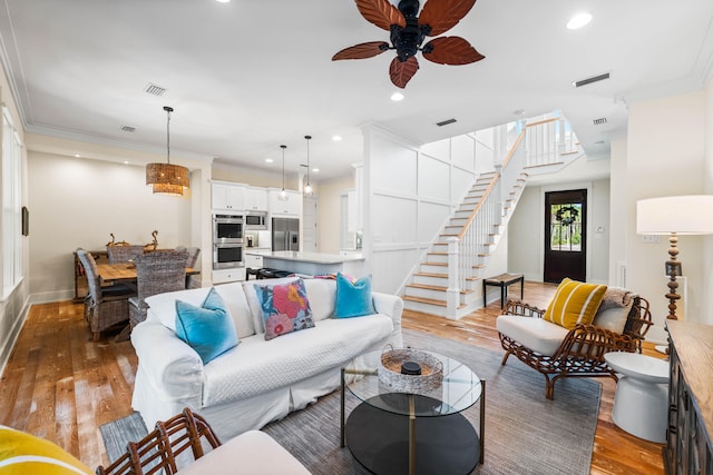 living room featuring ornamental molding, dark hardwood / wood-style flooring, and ceiling fan