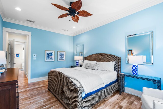 bedroom with ceiling fan, light wood-type flooring, and crown molding