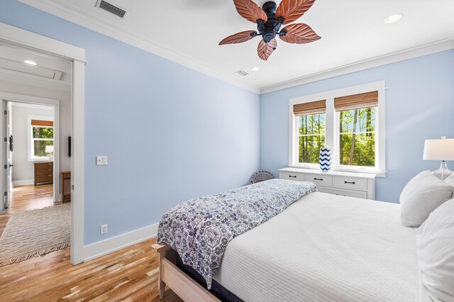 bedroom featuring ornamental molding, ceiling fan, and light hardwood / wood-style flooring