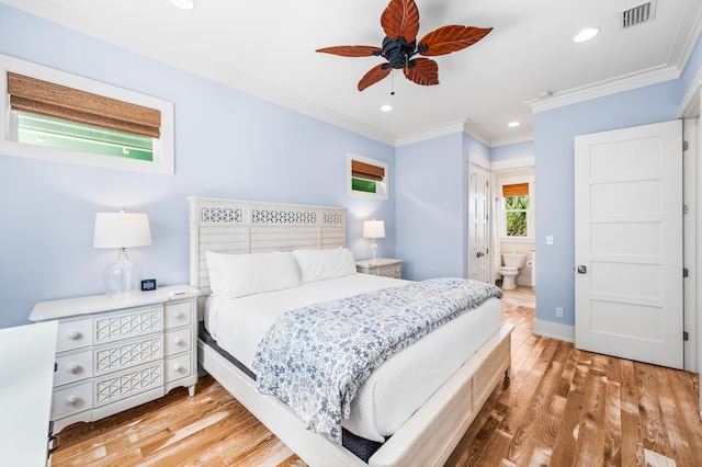 bedroom featuring ceiling fan, light hardwood / wood-style flooring, ensuite bath, and ornamental molding