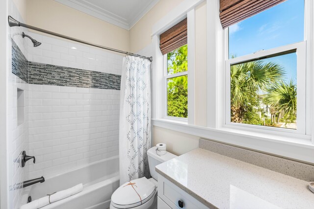 full bathroom with shower / bath combo with shower curtain, ornamental molding, vanity, and toilet