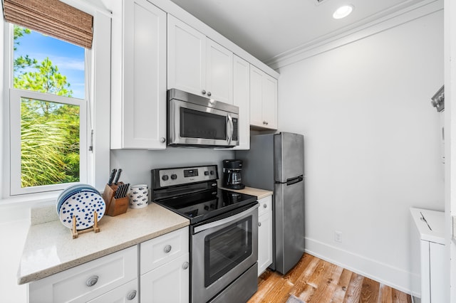 kitchen with white cabinetry, appliances with stainless steel finishes, and plenty of natural light