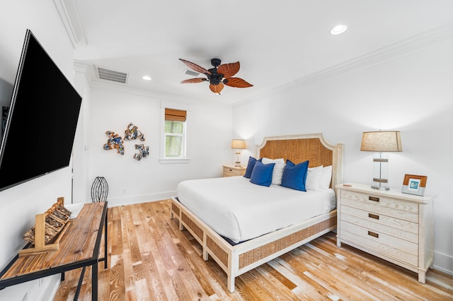 bedroom featuring light hardwood / wood-style flooring, ceiling fan, and crown molding