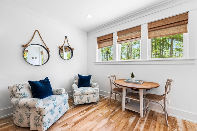 living area featuring ornamental molding and hardwood / wood-style floors