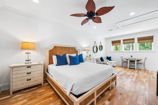 bedroom featuring ceiling fan, hardwood / wood-style floors, and crown molding