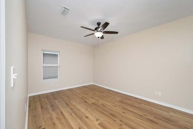 spare room with light wood-type flooring and ceiling fan