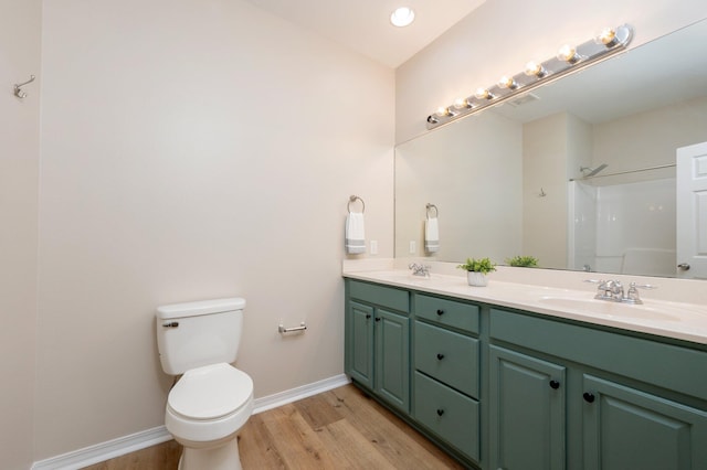 bathroom with a shower, vanity, toilet, and wood-type flooring