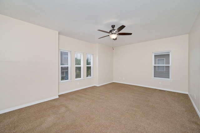 carpeted empty room featuring ceiling fan