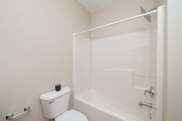 bathroom with shower / bathing tub combination and toilet