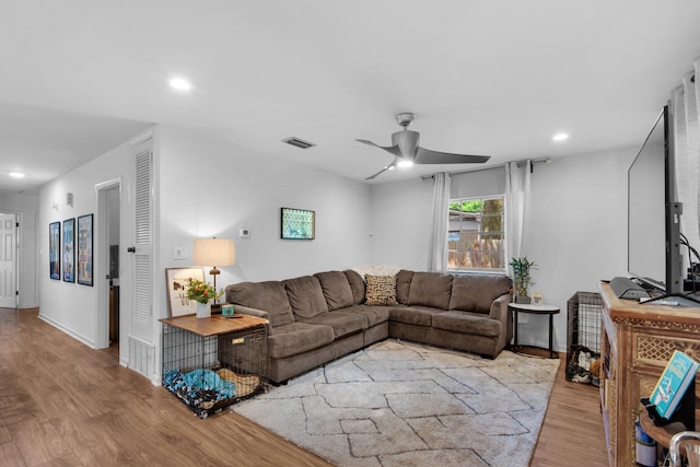 living room with ceiling fan and light hardwood / wood-style floors