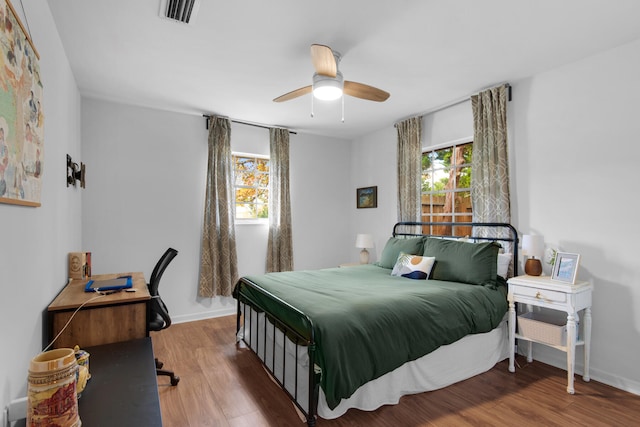 bedroom with ceiling fan and hardwood / wood-style flooring