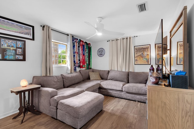 living room featuring light hardwood / wood-style flooring and ceiling fan