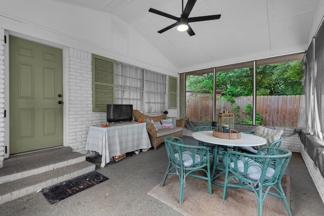 sunroom featuring ceiling fan and vaulted ceiling