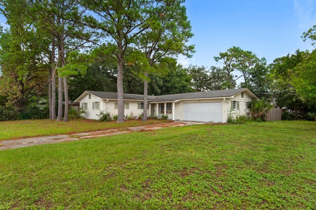 ranch-style house with a garage and a front yard