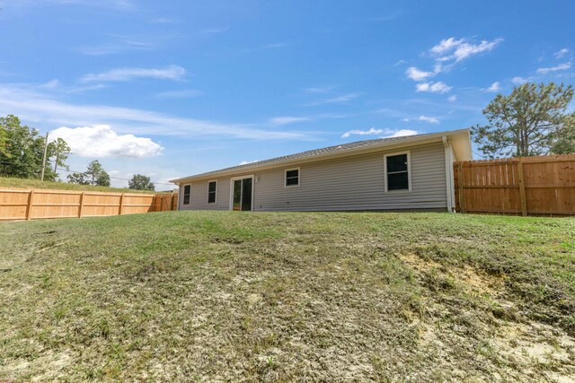 back of house with a yard