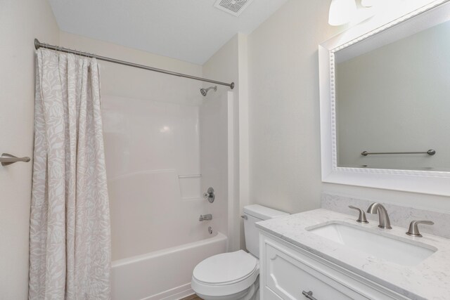 full bathroom featuring shower / bath combo, toilet, and vanity