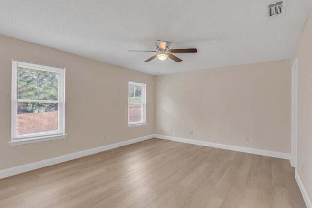 spare room with ceiling fan and light hardwood / wood-style floors