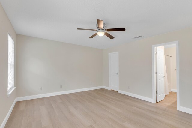 spare room featuring ceiling fan and light wood-type flooring