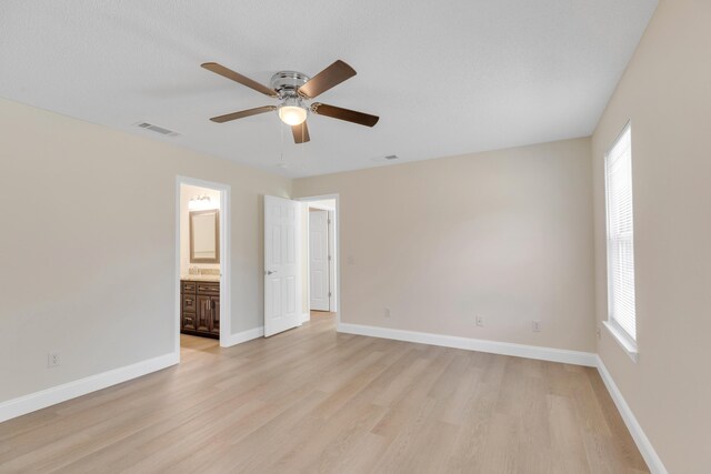 empty room with light wood-type flooring and ceiling fan