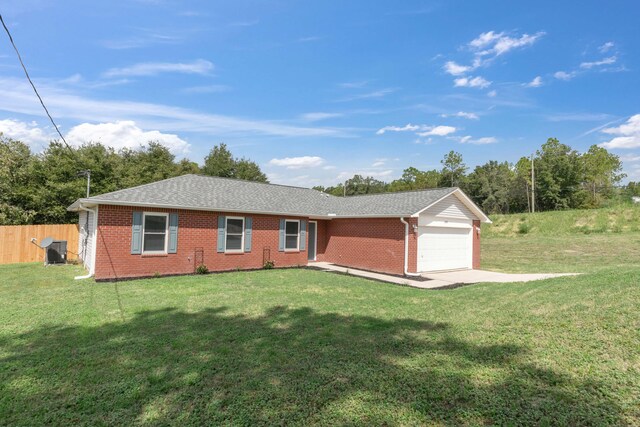 single story home featuring a garage, a front yard, and central AC unit