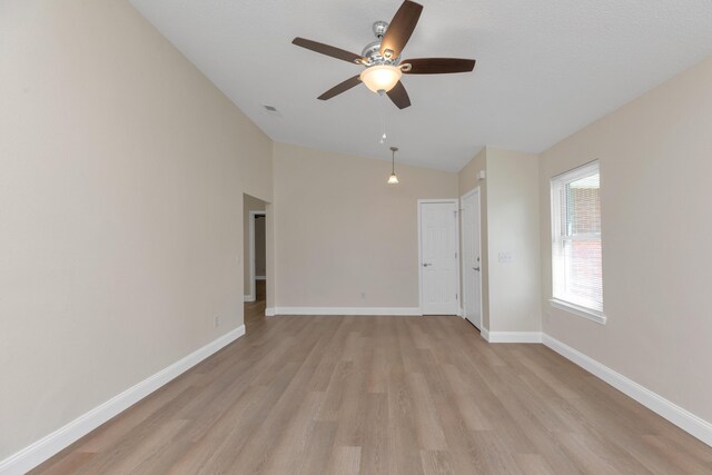 unfurnished room featuring ceiling fan, vaulted ceiling, and light hardwood / wood-style floors