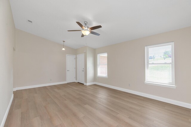 unfurnished room featuring lofted ceiling, ceiling fan, and light wood-type flooring