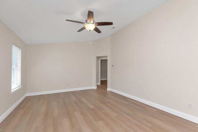 unfurnished room with light wood-type flooring, vaulted ceiling, and ceiling fan