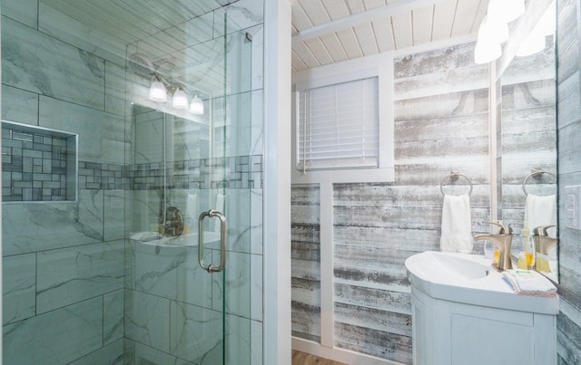 bathroom with vanity, wood ceiling, and a shower with door