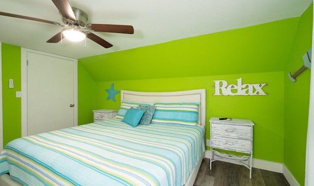 bedroom featuring vaulted ceiling, dark hardwood / wood-style flooring, and ceiling fan