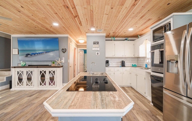 kitchen featuring black appliances, sink, wood ceiling, white cabinets, and light hardwood / wood-style floors