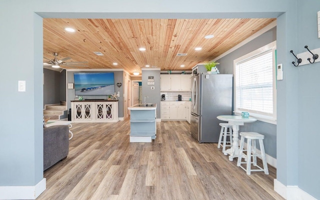 kitchen featuring wood ceiling, stainless steel fridge, white cabinets, and light hardwood / wood-style floors