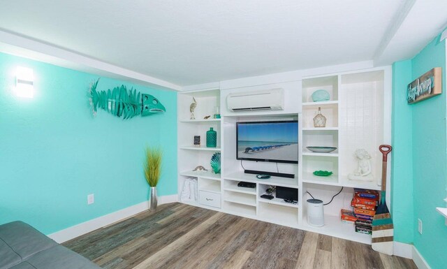 interior space with wood-type flooring and a wall mounted air conditioner