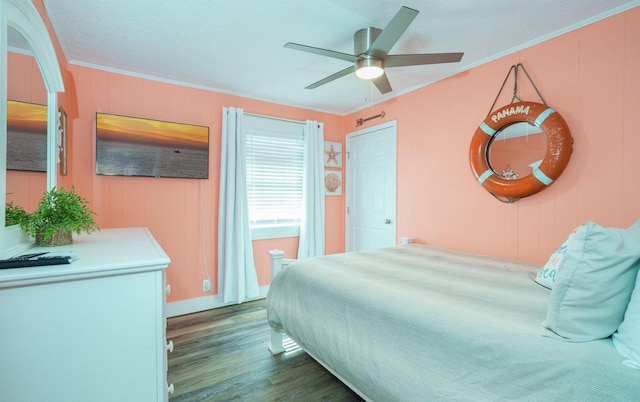 bedroom with ceiling fan, ornamental molding, and dark hardwood / wood-style flooring