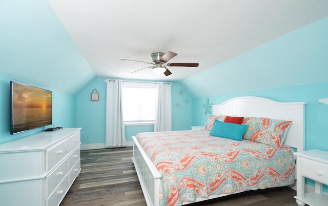 bedroom with dark wood-type flooring, ceiling fan, and lofted ceiling