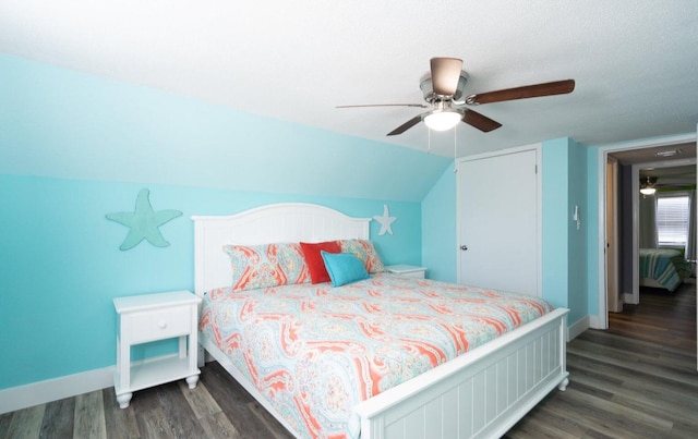 bedroom featuring vaulted ceiling, a textured ceiling, ceiling fan, and dark hardwood / wood-style floors