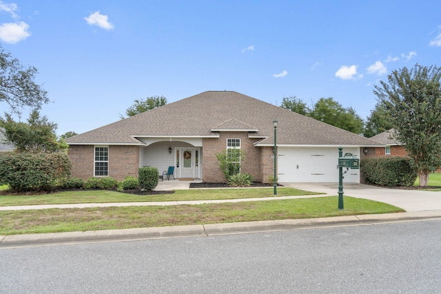 ranch-style home with a front yard and a garage