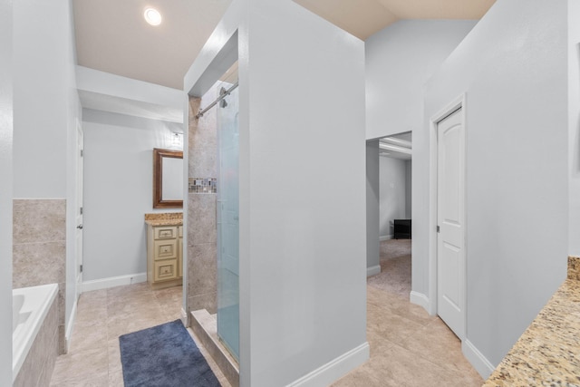 bathroom featuring vaulted ceiling, plus walk in shower, vanity, and tile patterned flooring